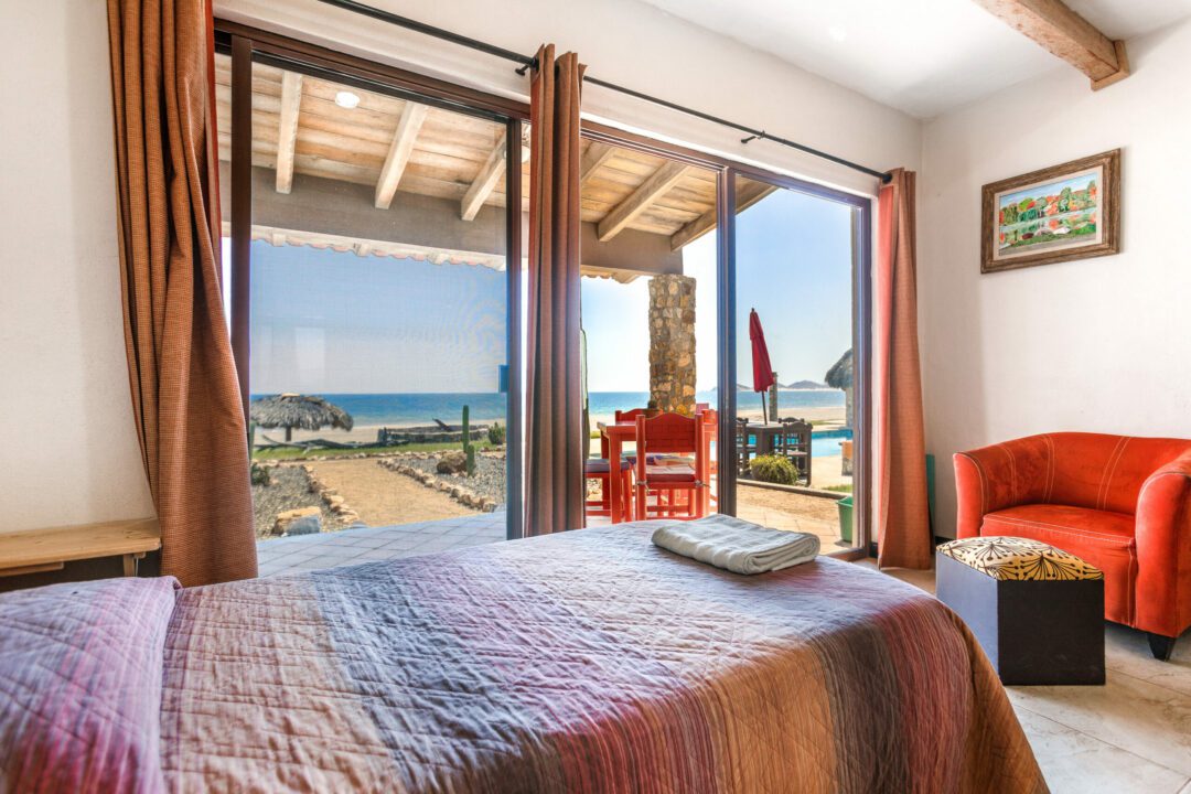 Ocean Front 4 (optional 5) twin beds, table for 4 and couch. This suite can be reconfigured for a couple and would include a sitting area. Private bathroom with shower, entry closet, Smart TV and Apple TV, TV/DVD, ceiling fan, A/C, Wi-Fi, and private patio.