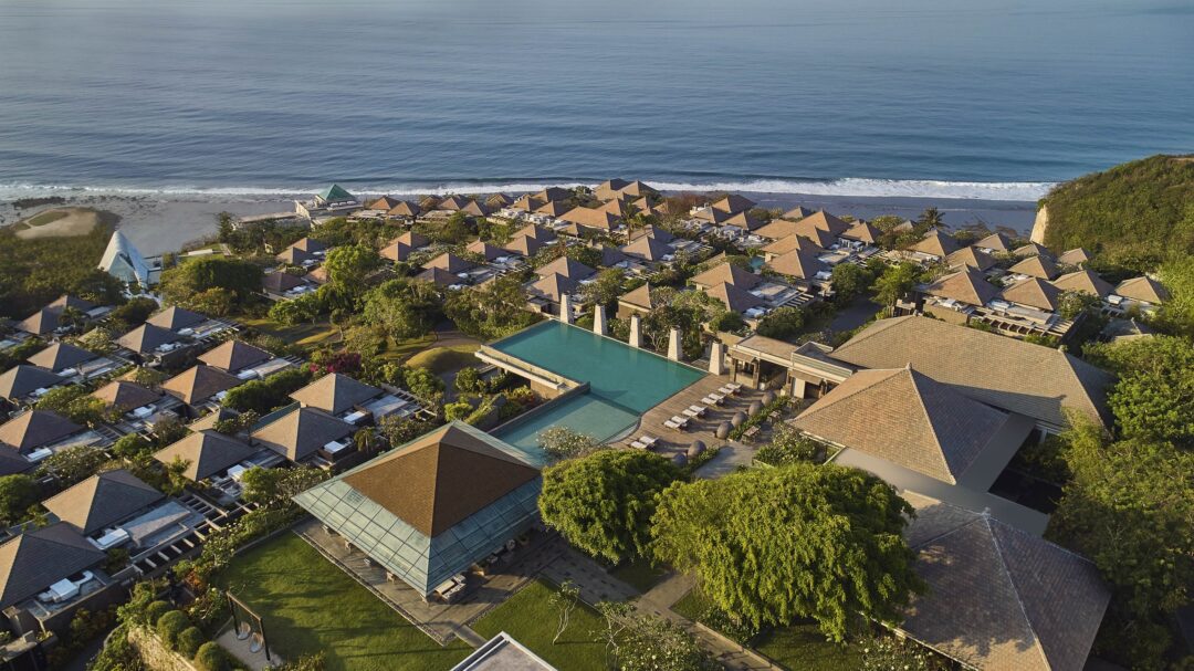 Aerial view of Umana Bali villas terraced down the Ungasan cliffs above the Indian Ocean